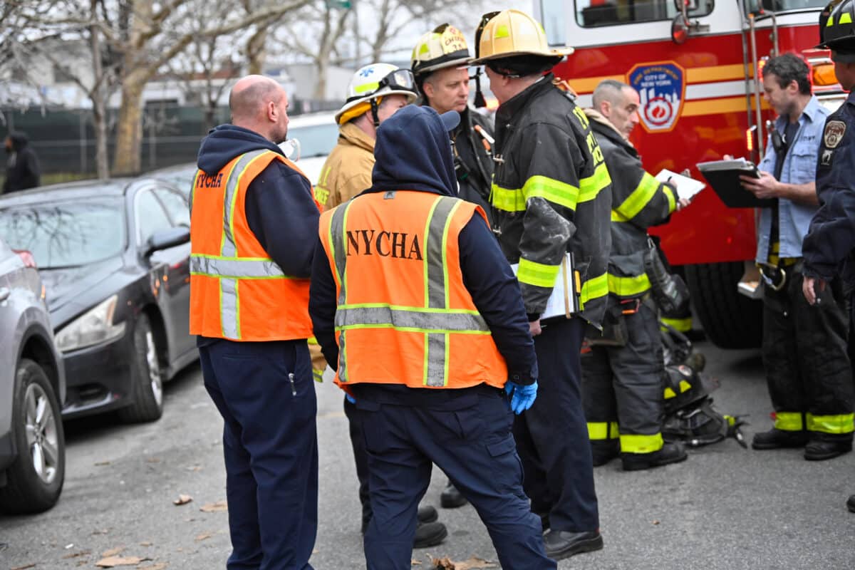 Firefighters and NYCHA officials at scene of Brooklyn high-rise fire