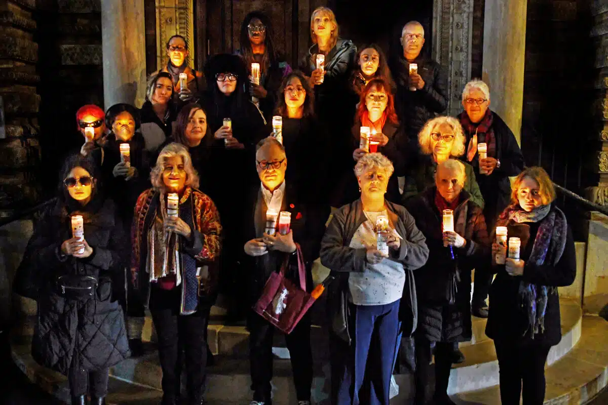 Greenwich Village vigil attendees holding candles for lost sex workers