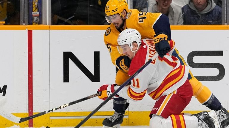 Nashville Predators defenseman Alexandre Carrier (45) and Calgary Flames center...