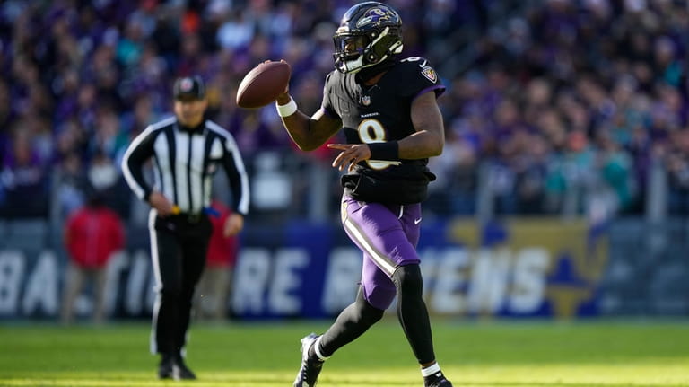 Baltimore Ravens quarterback Lamar Jackson (8) looks to pass as...