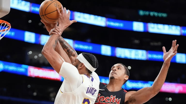 Los Angeles Lakers forward Anthony Davis, left, is fouled by...