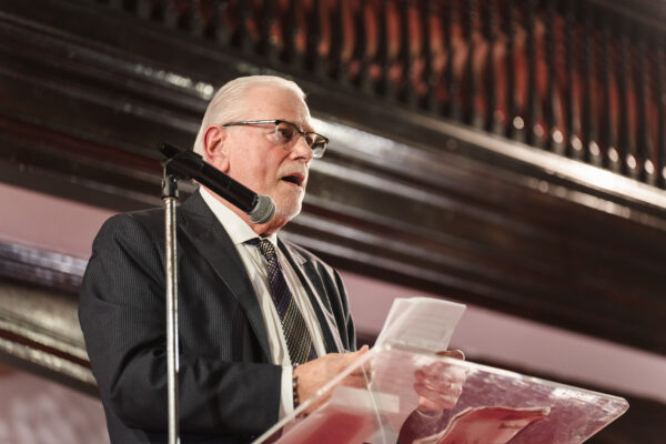 Attorney Michael Benjamin addresses the audience, highlighting Judge Lola Waterman’s anticipated impact on the legal profession.