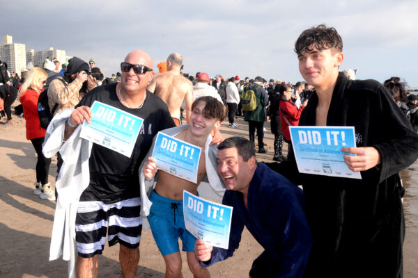 Participants celebrate their accomplishment of taking the plunge in the Coney Island water for a good cause.