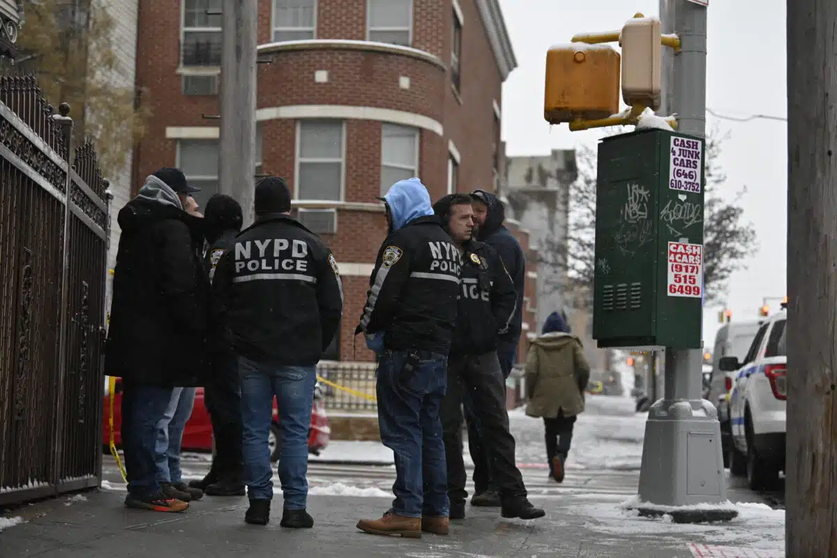 Police huddle after Brooklyn shooting