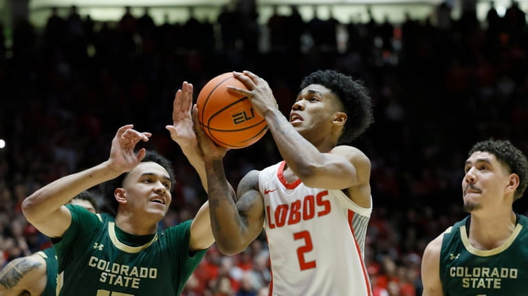 New Mexico guard Donovan Dent drives to the basket between...