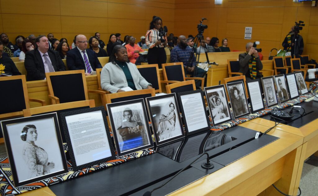 An educational display of portraits showcases influential Black artists and musicians, enriching attendees' understanding of Black history.