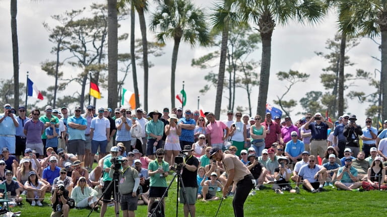 Xander Schauffele hits his putt on the second hole during...