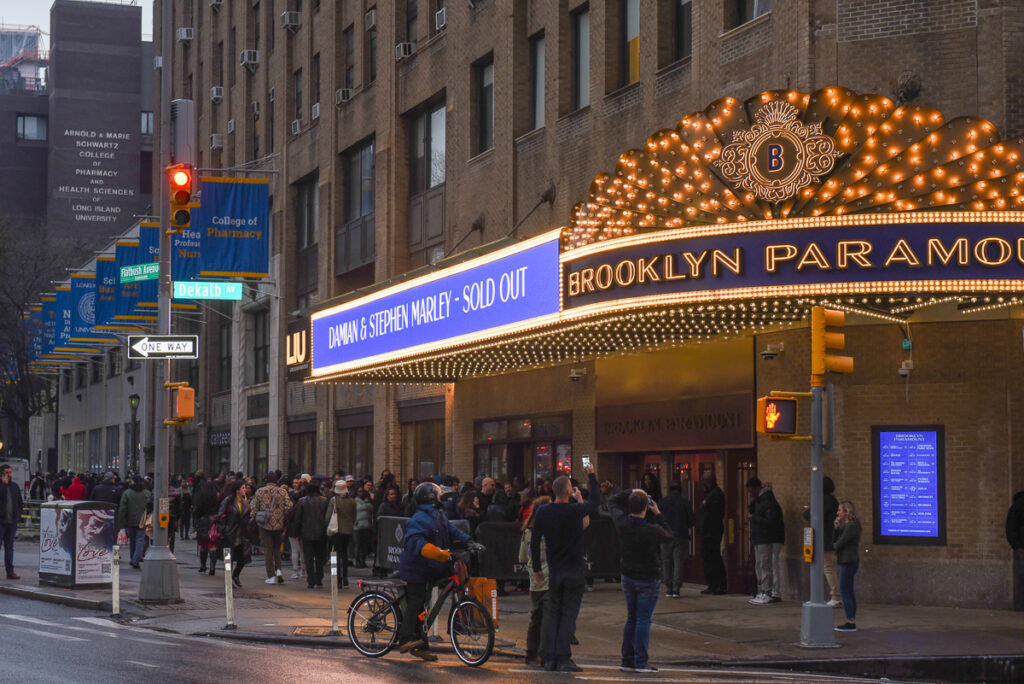 Passersby photograph the marquis of the Brooklyn Paramount on its opening night in Downtown Brooklyn.