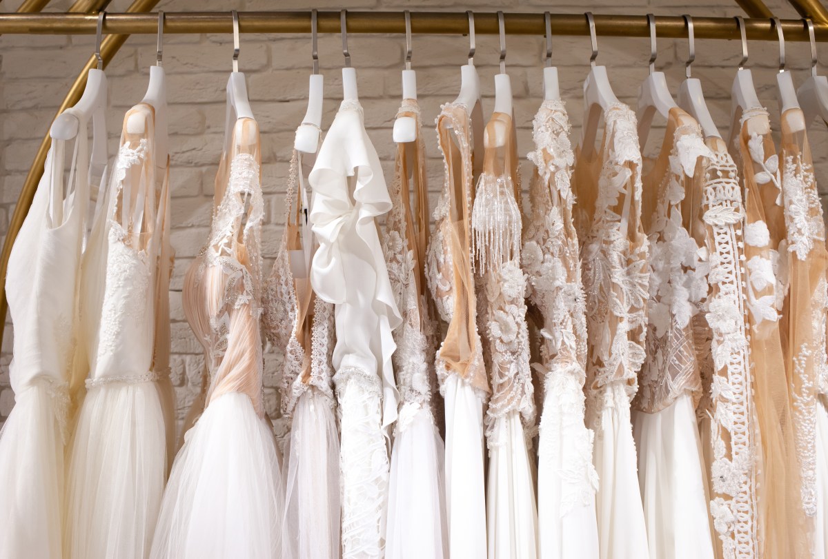 Many beautiful wedding dresses hang in the store