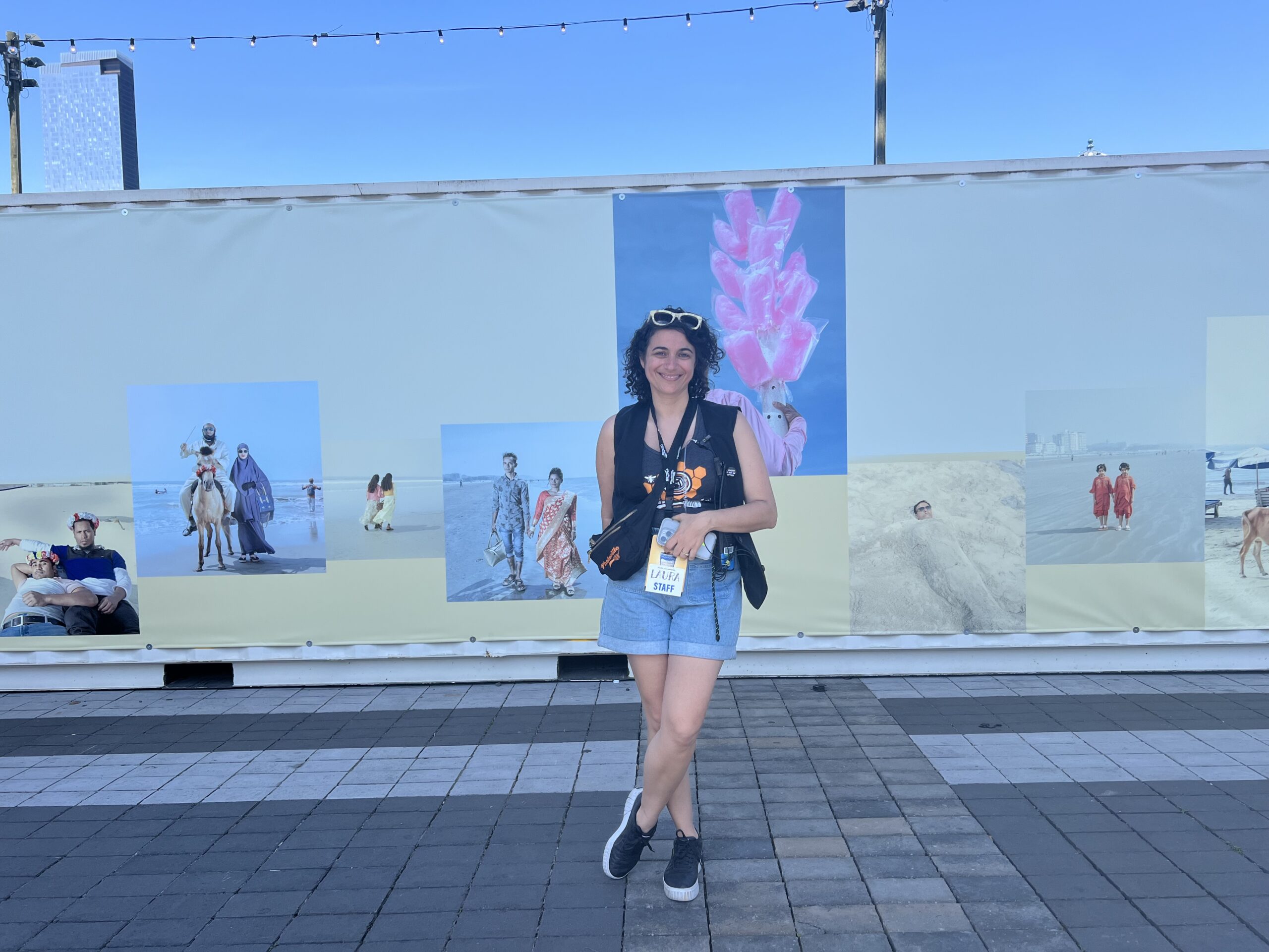 Laura Roumanos, co-founder and executive director of Photoville, standing by Ismail Ferdous’ “Sea Beach.”