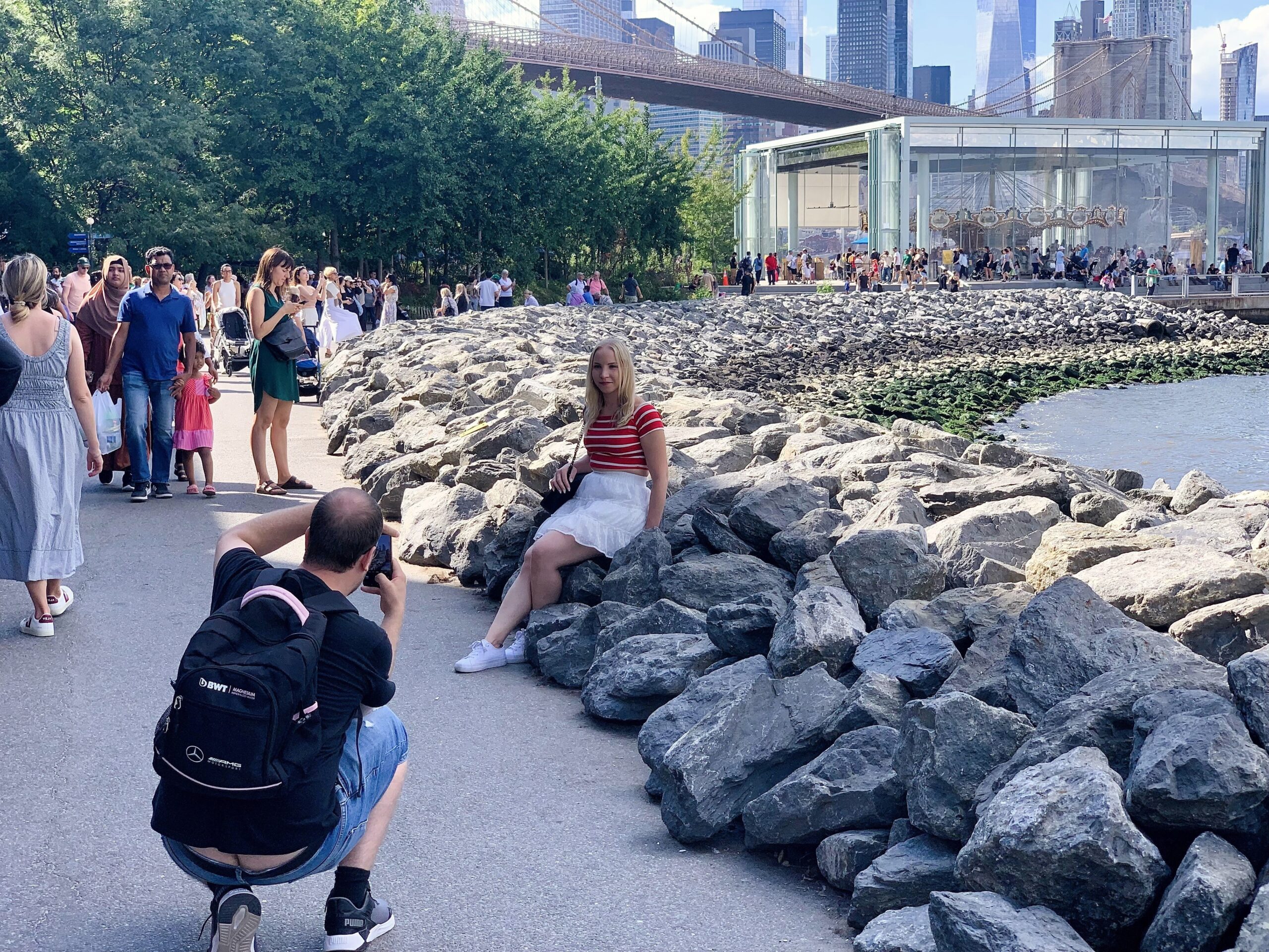 The rocks near Jane’s Carousel are a favorite place for visitors to pose for photo ops. Photo: Mary Frost, Brooklyn Eagle