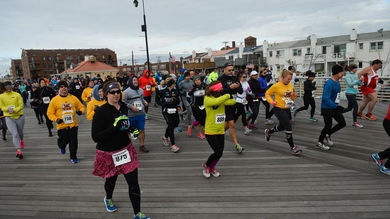 Participants run during the annual City Council Turkey Trot held...