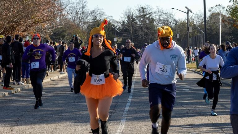 Aaron Howard and Sophia Pierre-Gatke run the Massapequa Thanksgiving Day...