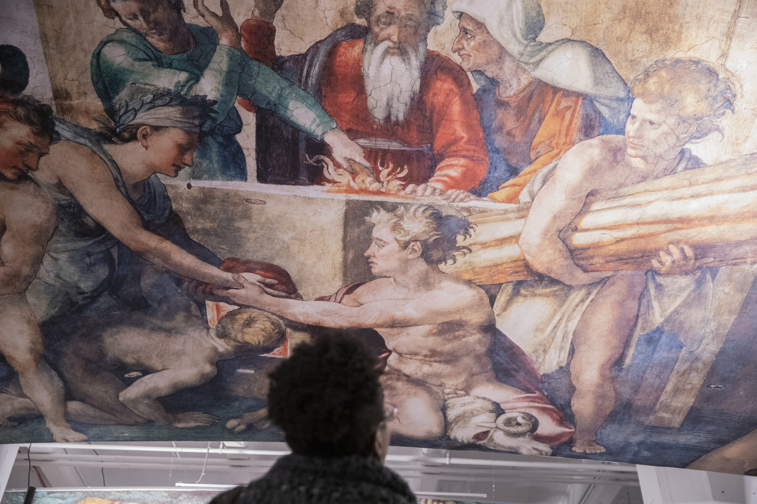 A guest takes in one of Michelangelo's ceiling pieces. Photo by John McCarten