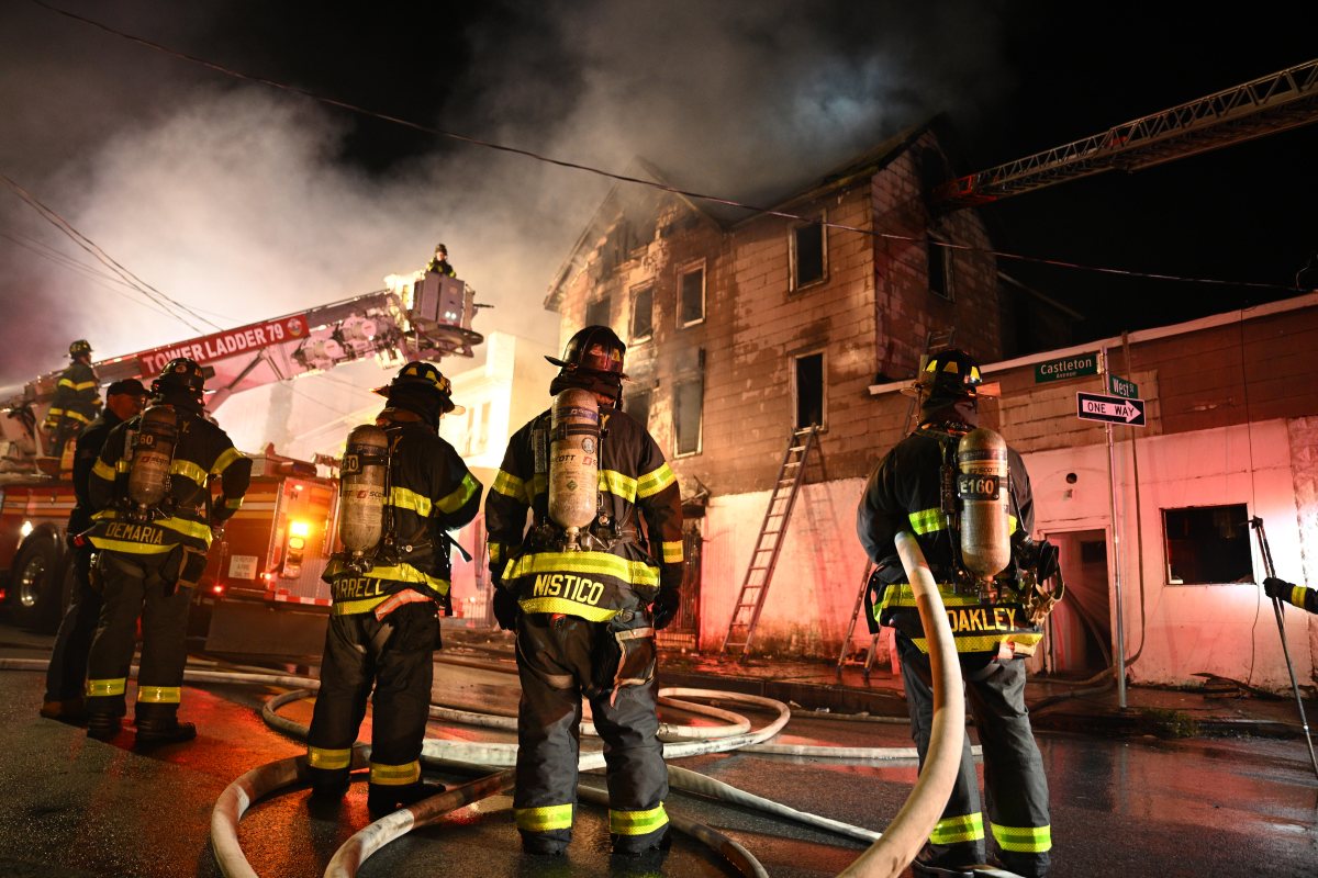 A firefighter battles heavy smoke and fire while battling a three alarm fire at 1074 Castleton Avenue.