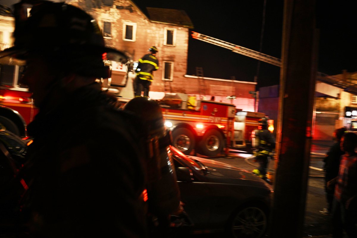 A firefighter battles heavy smoke and fire while battling a three alarm fire at 1074 Castleton Avenue.