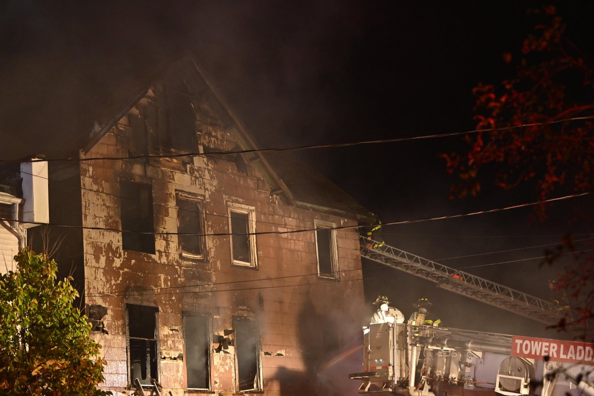 A firefighter battles heavy smoke and fire while battling a three alarm fire at 1074 Castleton Avenue.