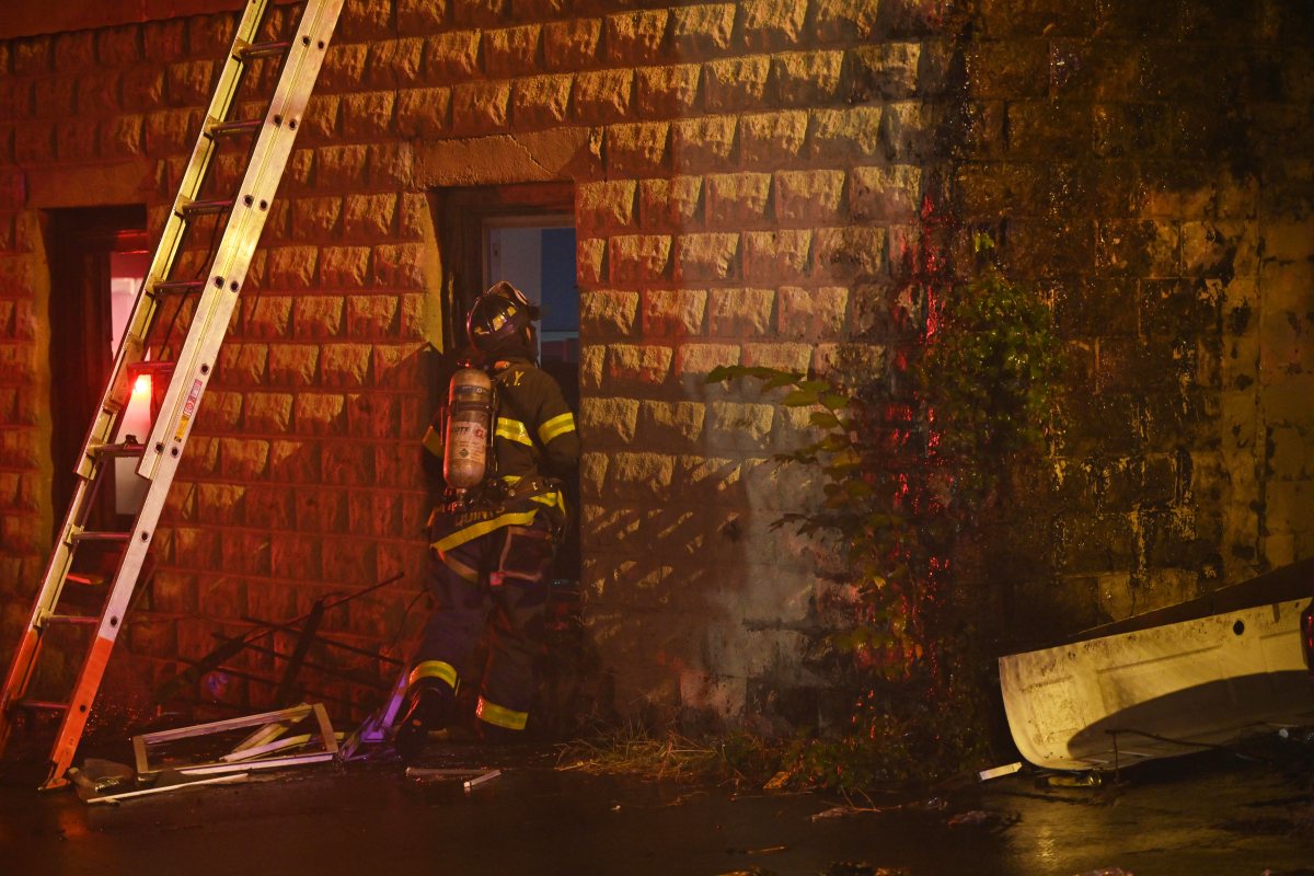 A firefighter battles heavy smoke and fire while battling a three alarm fire at 1074 Castleton Avenue.